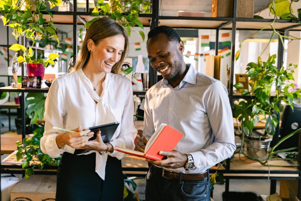 Employees Having Business Discussion holding an ipad and a notebook