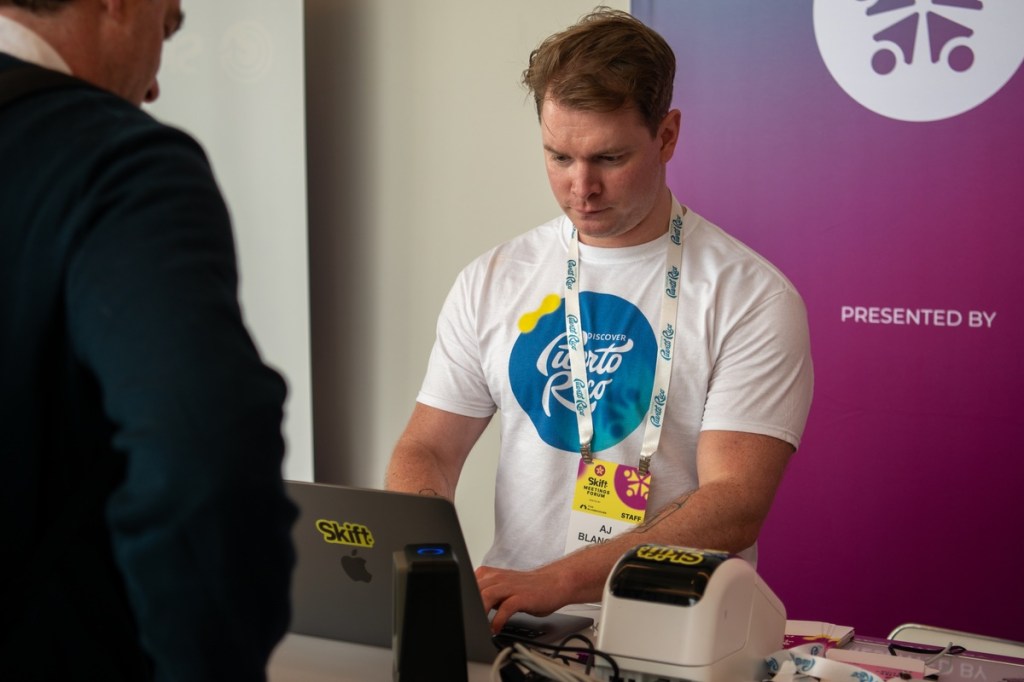 A man at an event registration desk