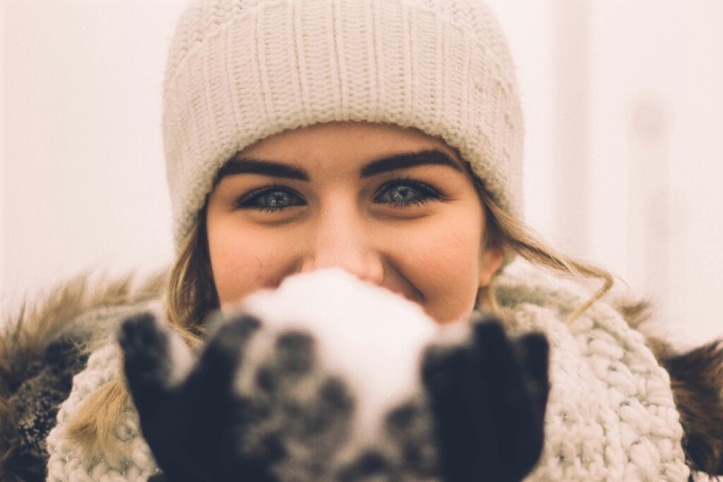 A girl holding a snowball in her hand