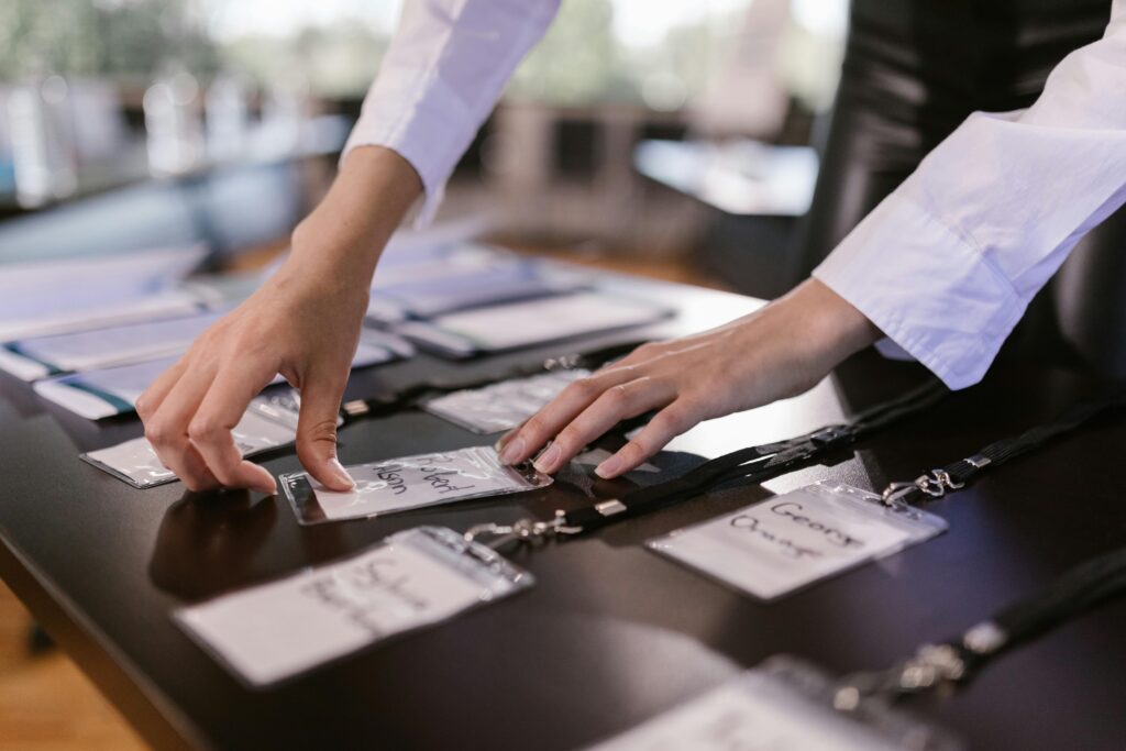 woman arranging name tags on a table at an event