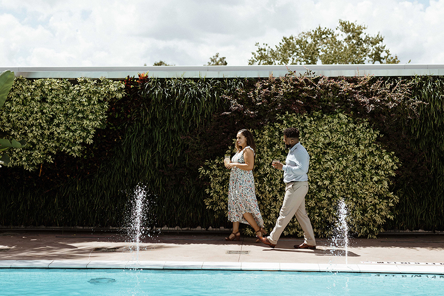 Two attendees stroll between a green wall and a pool, enjoying the kind of relaxation that typifies a new event trend toward more opportunities for self-care and wellness.