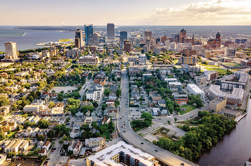 An aerial view of the Milwaukee skyline, showing plenty of green space and heritage buildings.
