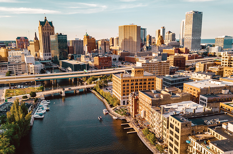 A view of Milwaukee's skyline and boats along the river, with Lake Michigan visible in the background.