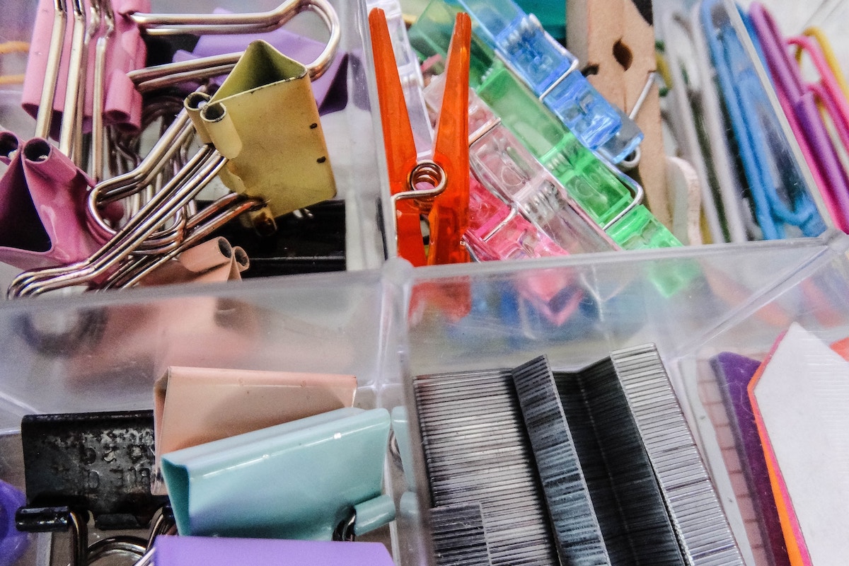 Assorted color plastic container on stainless steel rack photo