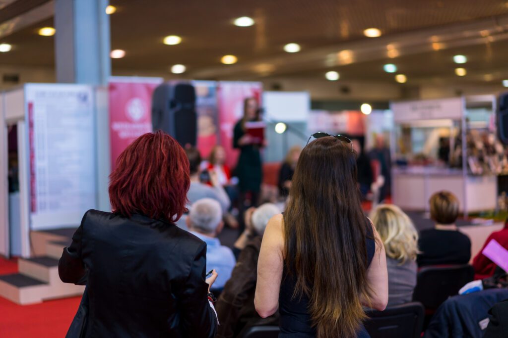 Attendees at a live demo at a trade show booth