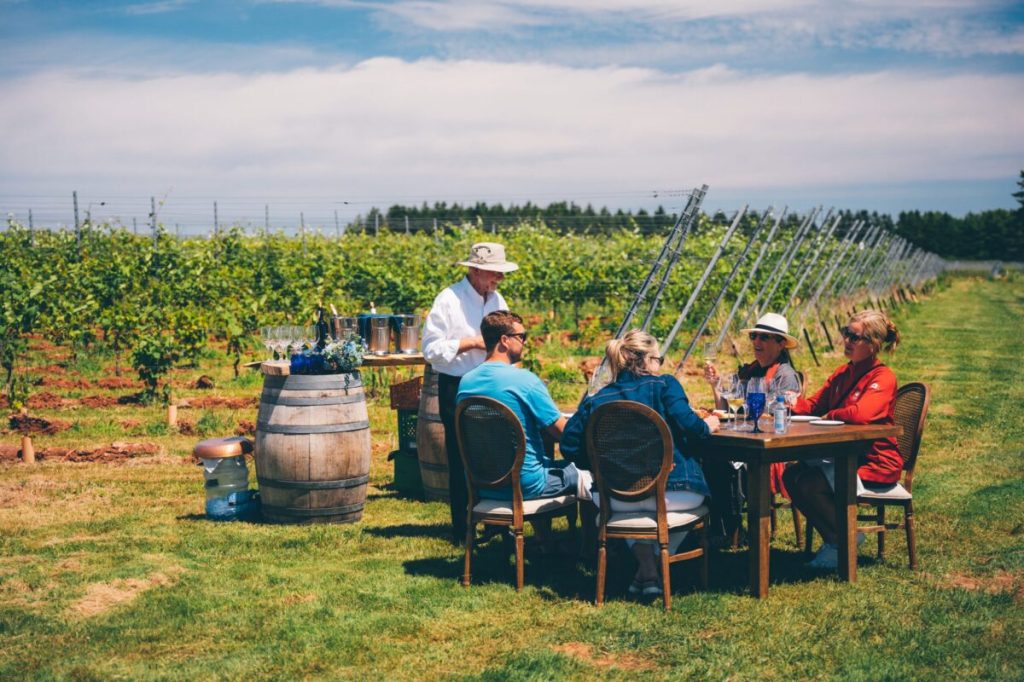 People sitting around a table in a winery