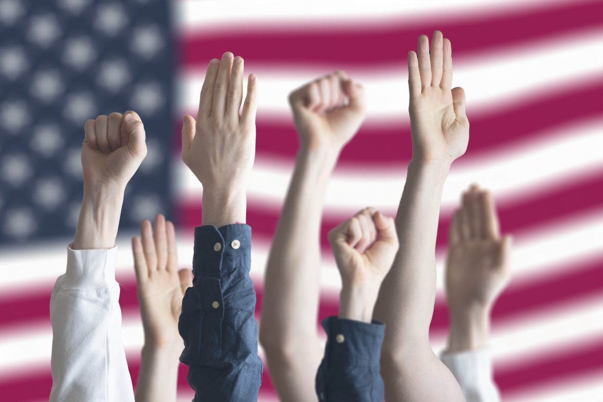 hands in front of U.S. flag representing advocacy over tariffs