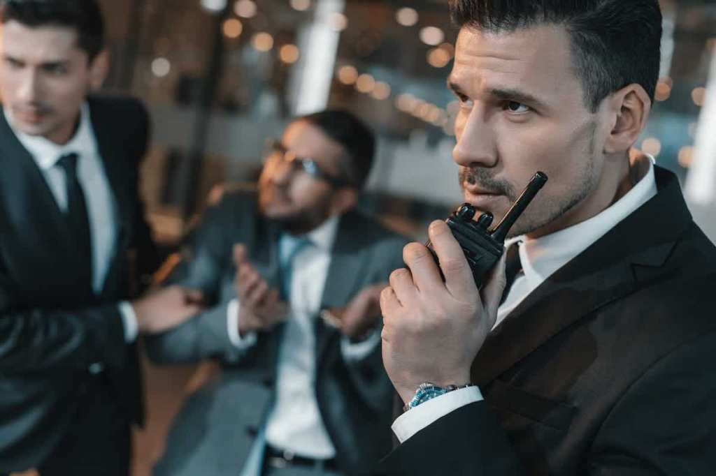 Security guard during a crisis talking in walkie talkie