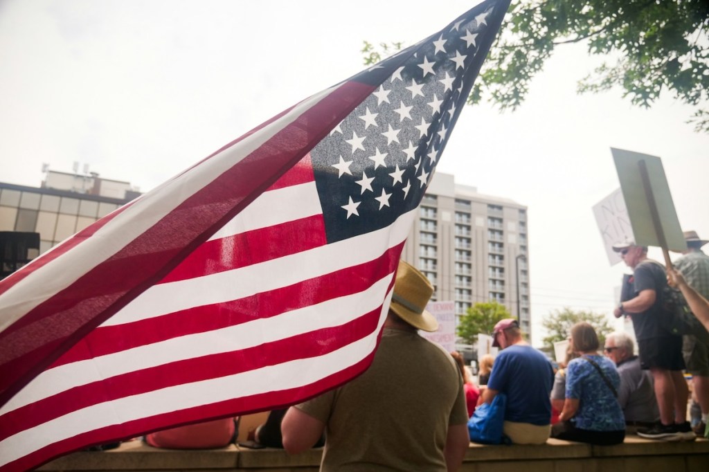 U.S. flag flying at a protest